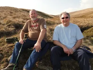Two walkers sitting on the moor in the sunshine